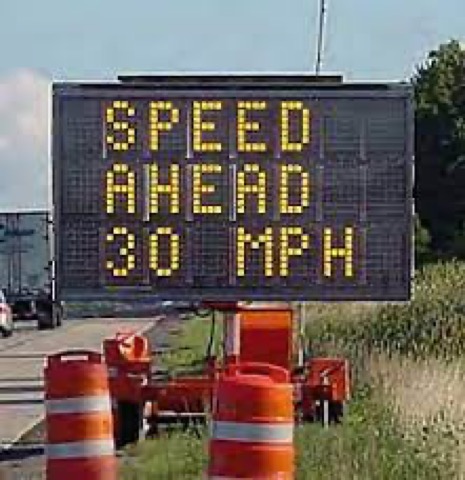 A portable changeable message sign reading SPEED AHEAD 30 MPH.